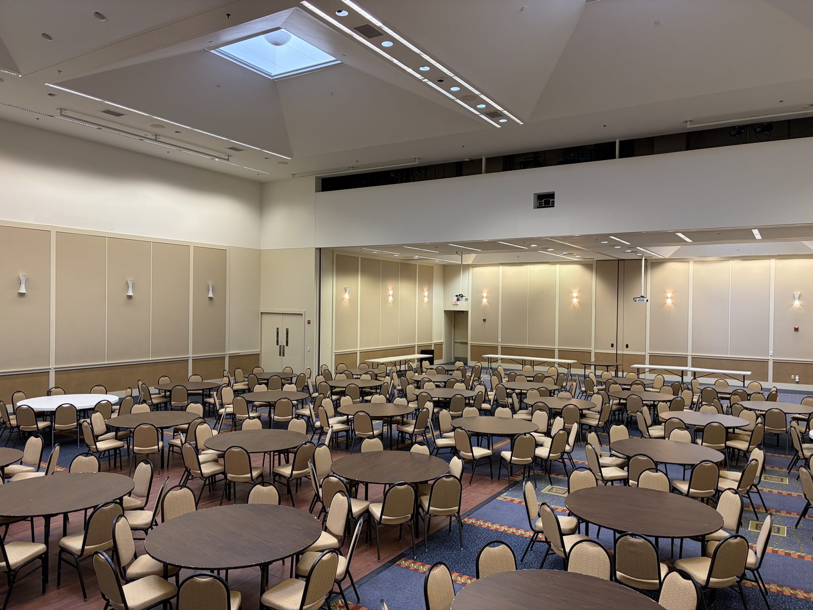 Large event banquet hall in Portland set with round tables and chairs, professionally cleaned by TBM Commercial Cleaning